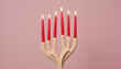 © Iryna - Minimalist candelabra shaped like intertwined fingers holding red candles, pastel background for an eerie yet elegant visual contrast