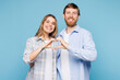 © ViDi Studio - Young couple two friends family man woman wear shirt casual clothes together showing shape heart with hands heart-shape sign isolated on pastel plain light blue background studio. Lifestyle concept.