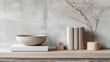 © nanskyblack - A minimalist arrangement features three textured, muted hardcover books, a small, wooden bowl, and a few wooden blocks, evoking a sense of tranquility and inviting contemplation.