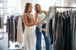 © standret - Checking the sweater. Two female friends are in the retail store, choosing clothes, shopping