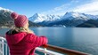 © Oksana - Woman gazes at snow-capped mountains and cruise ship during winter on a scenic coastal adventure in Alaska