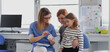 © Halfpoint - Girl showing her lost tooth to the dentist during a routine checkup at the dental clinic.