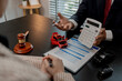 © kamiphotos - a lawyer is explaining the details of a car insurance policy to the car owner before she signs it, a lawyer explains to his client what will happen if she doesn't get car insurance