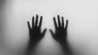 © Mamed - A blurry black-and-white photo of two hands behind foggy glass, creating an eerie atmosphere.