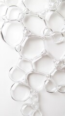 Poster - A collection of clear soap bubbles rests on a white surface, showcasing their intricate shapes and reflections under bright light, creating visual interest