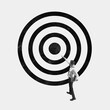 © master1305 - Businessman pointing at center of large target symbol. Concept of focus, goal achievement, success, determination, strategic thinking. Monochrome design. Business conceptual art.
