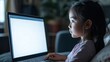 © Alexander - young girl intently watching a glowing laptop screen in a dimly lit room showcasing the digital engagement and modern childhood experiences