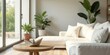 © kavalin - Serene living room interior design featuring a cozy sectional sofa, complemented by potted plants and a delicate paper boat ornament displayed on a wooden side table near a sunlit window.