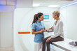 © Dragana Gordic - Healthcare Professional Assisting Patient in Modern Medical Imaging Facility