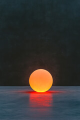 Poster - A neon-hued, orb-shaped light source in warm orange tones, poised over a faintly lined ebony floor,
