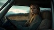 © Jittapon - A young Caucasian woman with blonde hair in a ponytail is driving a car solo through a scenic mountain landscape on a rural road  She has a thoughtful