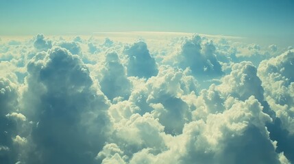 Poster - Breathtaking View of Fluffy White Clouds Against a Blue Sky Captured from Above, Evoking Serenity and Tranquility in Nature's Grandeur.