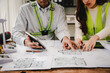 © Suphakant - Engineers work as a team with blueprints for architectural plans. Engineer sketching construction project concept with architect equipment Architects talking at table Teamwork and construction concept