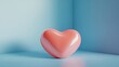 © ANUAR - Abstract glossy heart shape decoration against a soft pastel blue background creating a modern and minimalist aesthetic for various creative projects