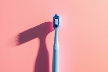 Poster - Blue toothbrush casting a shadow on a pastel pink background highlighting dental hygiene essentials