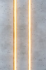Poster - Softly illuminated concrete surface showcases vertical golden light streaks, creating a smooth industrial texture. The space offers a luxurious and minimalist aesthetic for diverse design uses