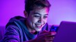 © Olga - Digital Activism,, addiction to web, Teenage boy smiling while using a smartphone and laptop in a digital activism environment