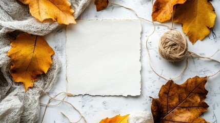 Poster - Autumn leaves are arranged around a blank paper on a table