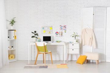 Poster - Interior of designer's office with workplace, shelf unit and folding screen