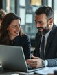 © Alexander Chaykin - Smiling business professionals in discussion over laptop