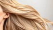 © thanarak - Detailed close up view showcasing the luscious texture and vibrant color of a woman s blonde hair highlighted by soft warm lighting that creates a radiant glamorous effect
