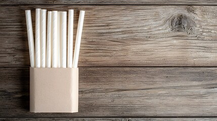 Aufkleber - Matte white paper straw lying flat inside a simple unbranded paper sleeve on a rustic wooden surface  Minimalist eco friendly and sustainable product presentation for branding packaging