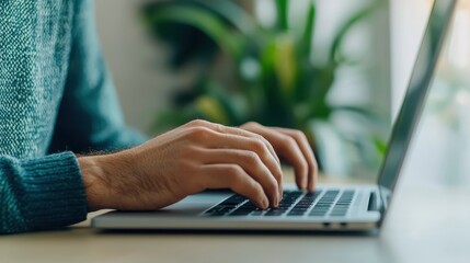 Poster - A person typing on a laptop with a focus on their hands, surrounded by a green plant, indicating a productive work or study environment.