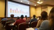 © Stephen - Attendees at Presentation with Bar Graph on Screen.