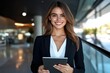© Woodyphoto - Confident young woman modern office portrait professional setting eye-level empowerment