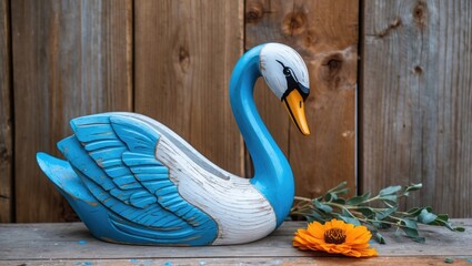Poster - Painted wooden swan decoration in blue with flower and greenery on rustic wooden background