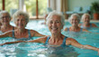 © miss irine - Group elderly women enjoy hydrotherapy exercise in indoor pool. Senior ladies smiling during water aerobics class, rehabilitation in nursing home. Active retirement lifestyle, healthcare concept.