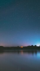Wall Mural - Lyepyel District, Vitebsk Province, Belarus. Real Colorful Night Stars Above Lepel Lake. Natural Starry Sky Background Backdrop Landscape. Time lapse.