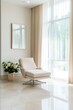 © Iryna - A white chair is sitting in front of a mirror and a vase of flowers. The chair is facing a window with white curtains. The scene is simple and elegant, with the white chair