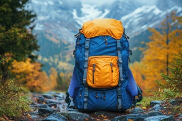 Poster - A blue and orange backpack sits on a rocky trail, perfect for outdoor enthusiasts to use in adventure-themed projects