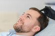 © Serhii - Doctor marking young man's forehead with hair loss problem