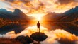 © Jasper - Person standing on a rock at sunset, overlooking a lake and mountains. Golden sunlight illuminating the horizon. Peaceful nature scene.