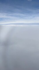 Wall Mural - Airplane Window View Blue Sky Above the Clouds UGC video