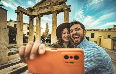happy couple of tourist taking selfie picture in front of old ancient in city street - boyfriend and