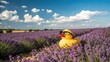 © Володимир Виповський - A small yellow toy duck, wearing black sunglasses, stands in the middle of a vast field of blooming lavender.