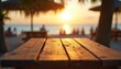 © Vadym - Wooden planks table top with scenic sunset sea view background. Beach with relaxing people and palm trees. Warm golden sun light and tranquil atmosphere at ocean shore.