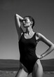 © CarloSanchezPereyra - Black and white portrait of a woman in a swimsuit at the beach, highlighting elegance and classic beauty.