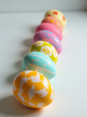 Poster - A Vibrant Display Of Colorfully Decorated Easter Eggs In A Single Row Adds Festive Charm To Any Table Setting Easily.