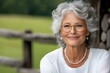 © Miroslav - Smiling senior woman with gray hair and glasses enjoying retirement in the countryside