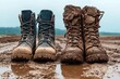 © Paul - A pair of rugged leather work boots, one clean and the other heavily caked in mud, standing side by side on a wet, dirt road with puddles  - AI Generated Digital Art.