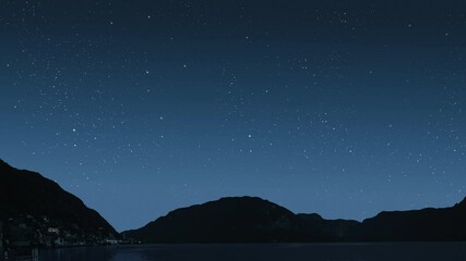 Wall Mural - a a movement of stars in the night sky with the view of mountains.