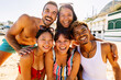 © Xavier Lorenzo - Portrait group of cheerful multi-ethnic friends having fun together on a sunny beach, enjoying summer holidays and laughing