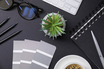 Aufkleber - Designer's workplace with keyboard, stationery and cup of coffee on black background, flat lay