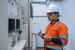 © reewungjunerr - Electrical engineers and technicians work together to solve electrical system failures in industrial control rooms.supervisor maintains the circuit cabinet.