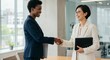 © Outkast - Businesswomen shaking hands, office meeting