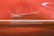 © esvetleishaya - Close up of a red car with multiple visible scratches and paint damage The scratches expose the underlying metal, creating a contrast against the glossy surface. Perfect for automotive damage concepts